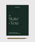 The State of You journal from Superstate, with a dark green cover, elegant white text and a gold pen beside it.