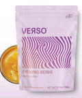 Verso Evening Being supplement pouch with a vibrant design, alongside a glass of orange drink, promoting relaxation and sleep.